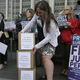An activist from the advocacy group UltraViolet stacks boxes containing one million signatures to the California Commission on Judicial Performance calling for the removal of Judge Aaron Persky from the bench during a rally Friday, June 10, 2016, in San Francisco. Photo via AP.